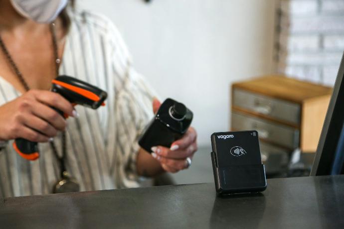 A woman wearing a face mask holding two cameras