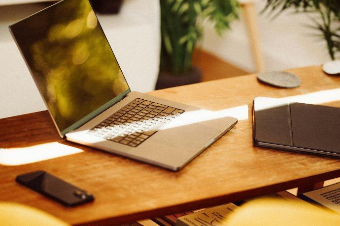 A laptop computer sitting on top of a wooden desk