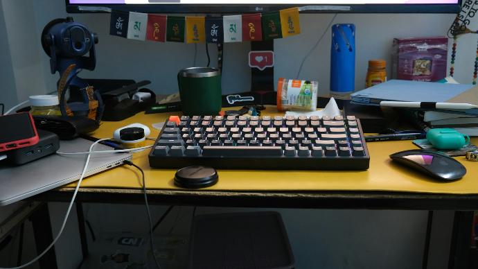 a computer keyboard sitting on top of a yellow desk