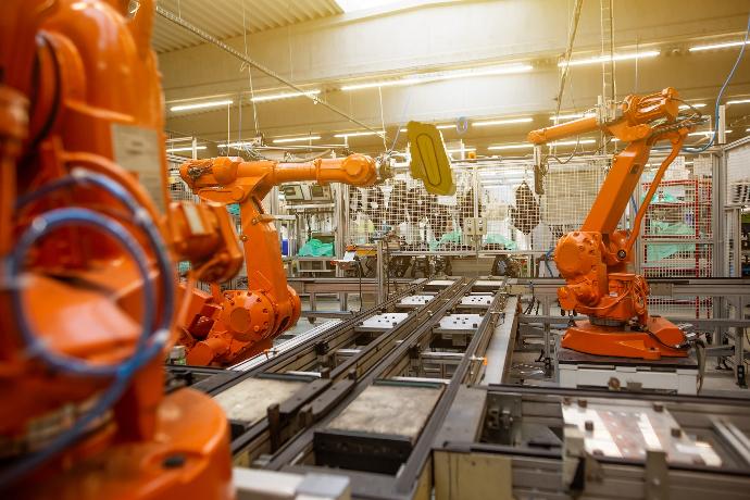 a factory filled with lots of orange machines