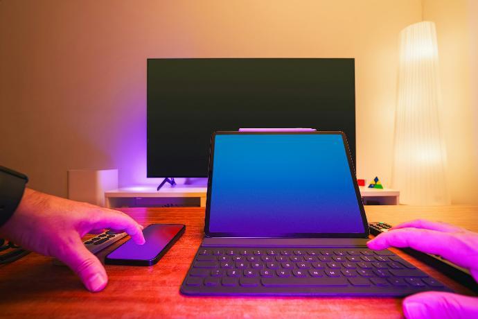 A person sitting at a desk using a laptop computer